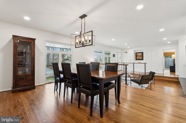 a view of a dining room with furniture wooden floor and chandelier
