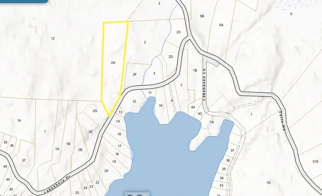 a picture of a white wall with a white comforter and chair