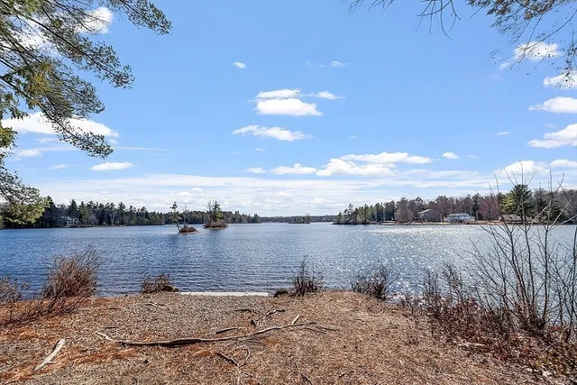 a view of a lake with houses in back