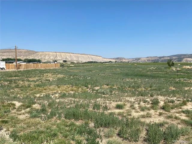 a view of a field with an ocean view