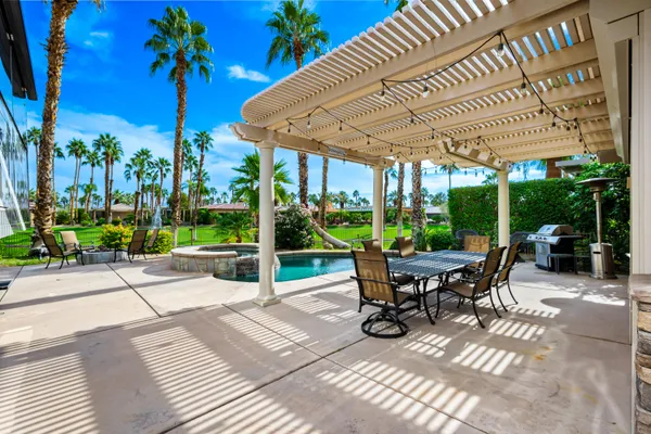 a patio view with a table and chairs