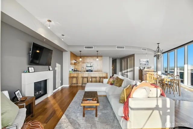 a living room with furniture a fireplace and a flat screen tv