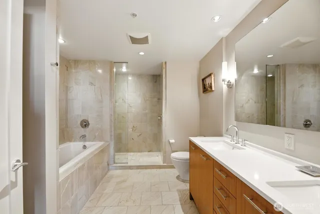 a bathroom with a bathtub and a shower