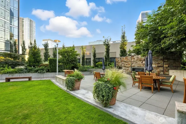 a living room with furniture a fireplace and a floor to ceiling window