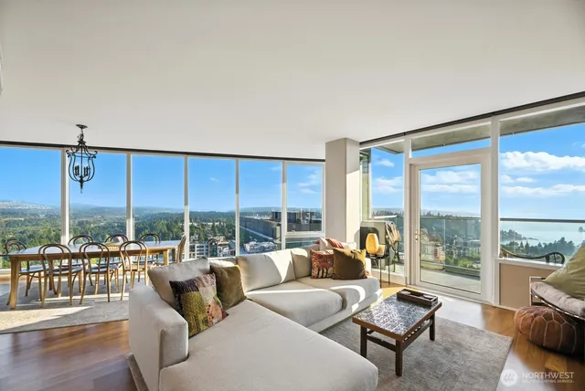 a living room with furniture and a floor to ceiling window