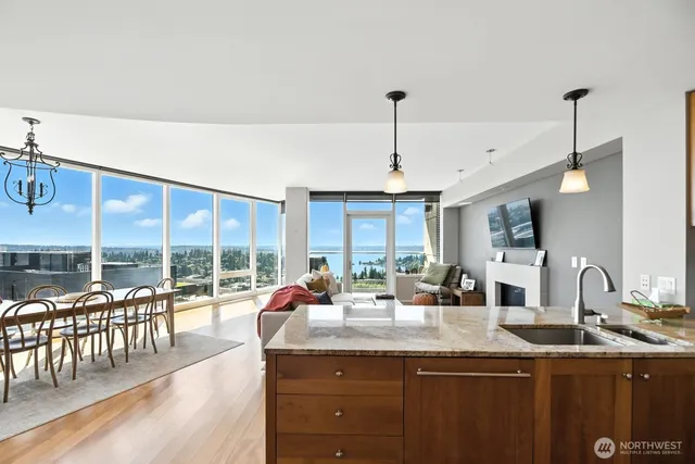 a kitchen with kitchen island granite countertop a sink and a stove