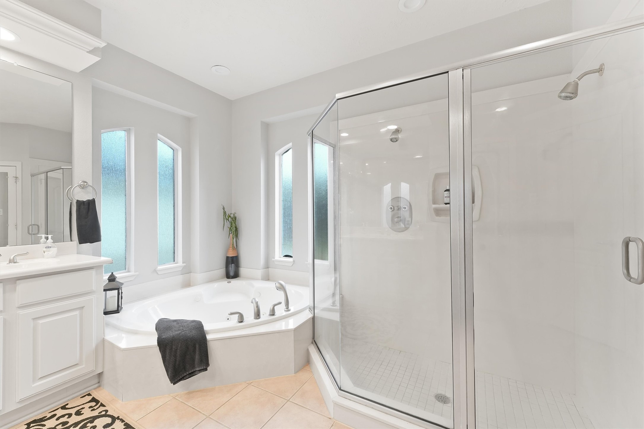 2818 Shallow Springs Court Manvel, TX 77578 - Photo 22 of 41 a bathroom with a bathtub shower sink and mirror