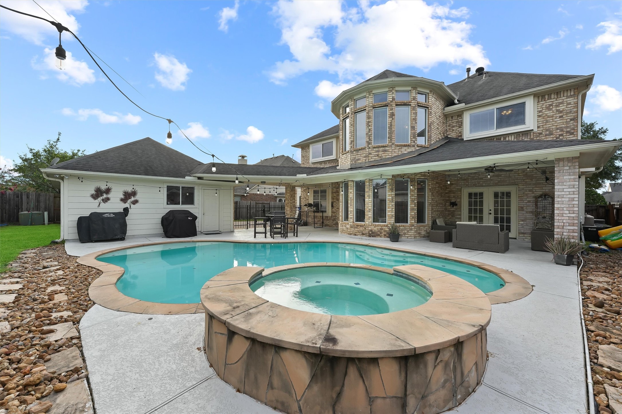 2818 Shallow Springs Court Manvel, TX 77578 - Photo 34 of 41 a view of a white house with a swimming pool