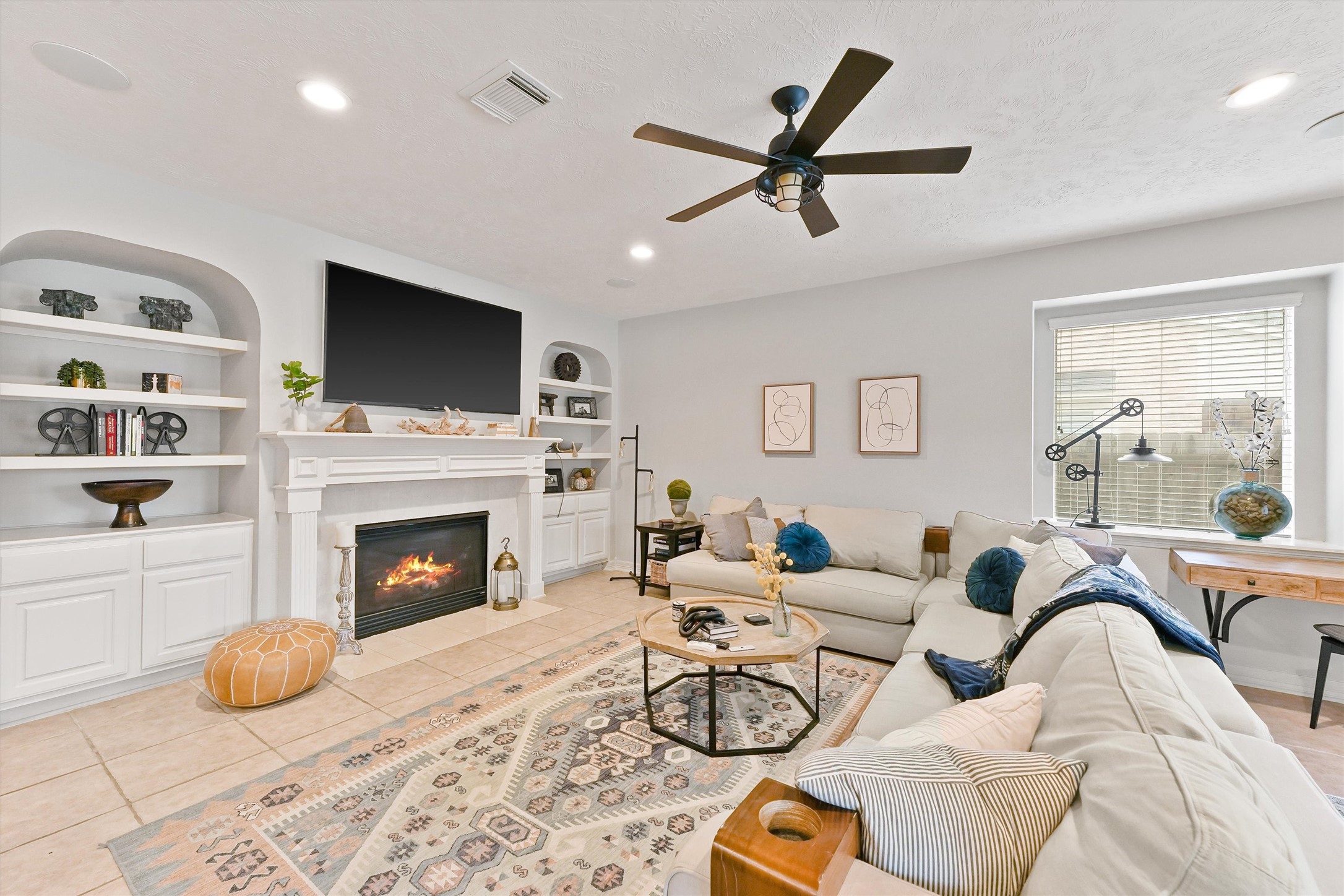 2818 Shallow Springs Court Manvel, TX 77578 - Photo 10 of 41 a living room with furniture a flat screen tv and a fireplace