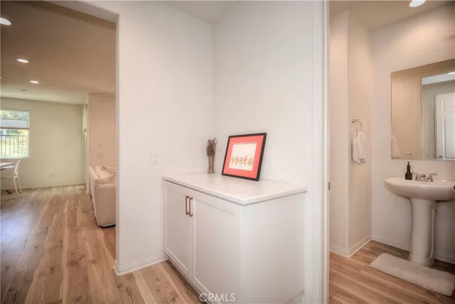 a room with wooden floor and a sink
