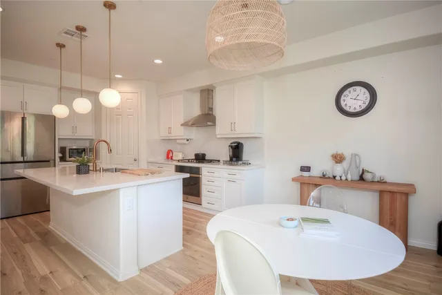 a kitchen with a sink stove and cabinets