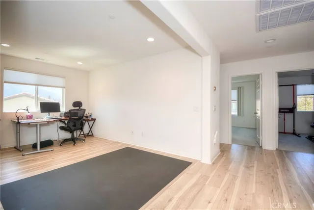 a view of a workspace with furniture and a window