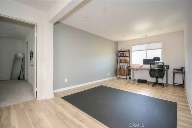 a view of a livingroom with workspace and a window