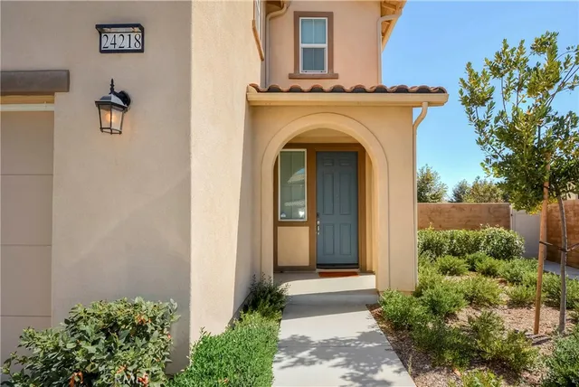 a view of a house with entryway and plants