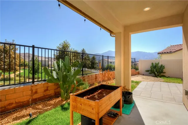 a backyard of a house with table and chairs