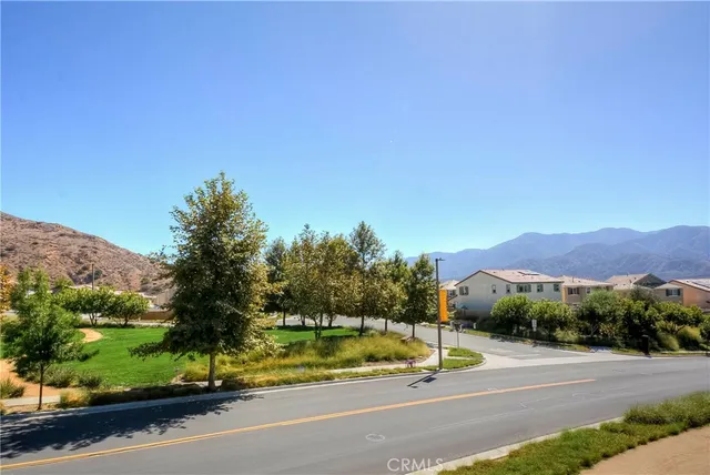 a view of a road with a barn in the background