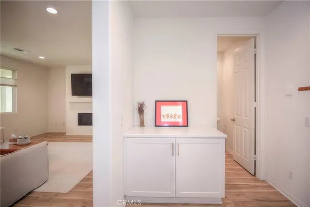 a view of a hallway with workspace and a window