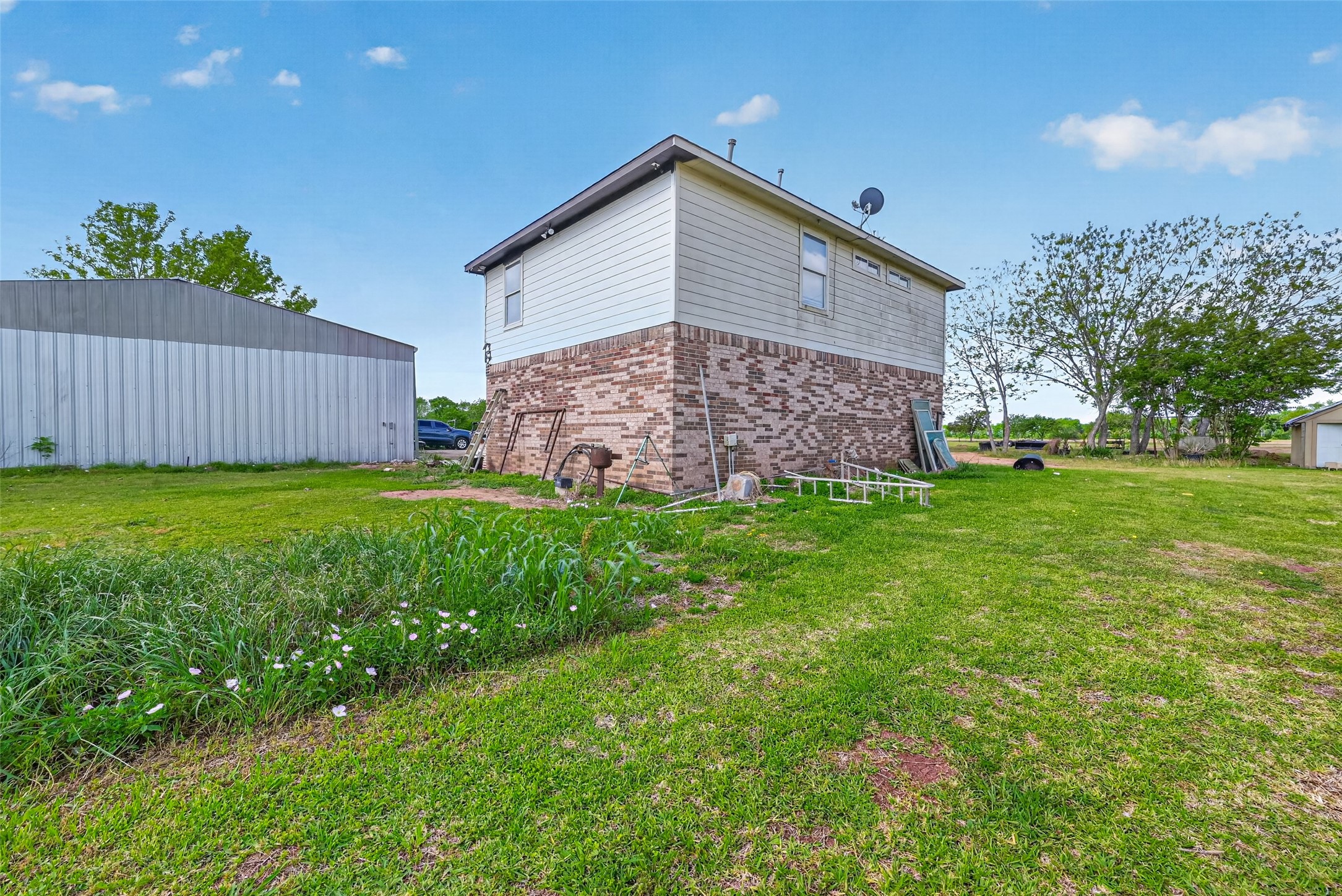 8023 Pool Hill Road Fulshear, TX 77441 - Photo 44 of 50 a view of a house with a yard and a garden