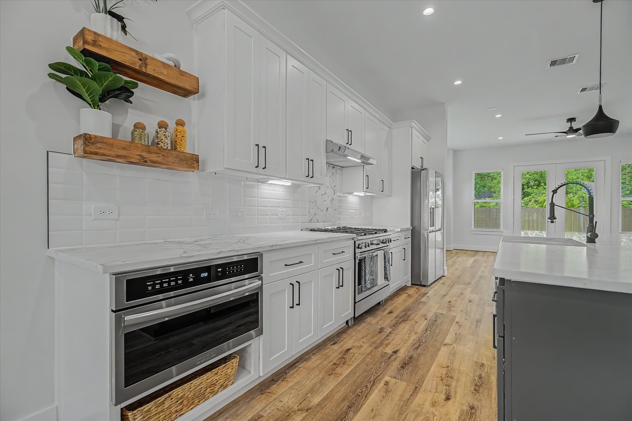 3806 Dreyfus Street Houston, TX 77021 - Photo 12 of 48 Features a 36-inch Frigidaire Gallery dual-fuel range with air fry and a 30-inch built in microwave oven with drop down drawer.