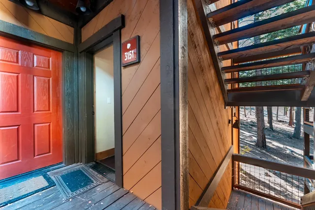 a view of a tennis ground with large trees