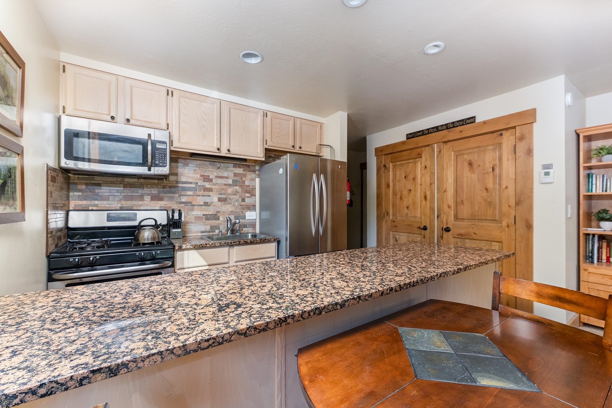 3151 Aspen Grove Truckee, CA 96161 - Photo 7 of 18 a kitchen with stainless steel appliances granite countertop a refrigerator and a stove top oven