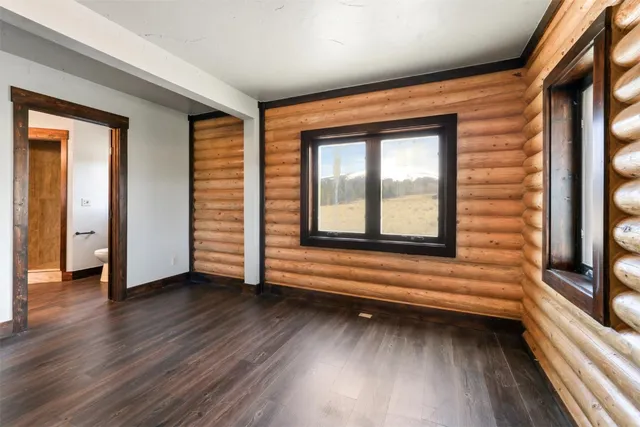 a view of a room with wooden floor and windows