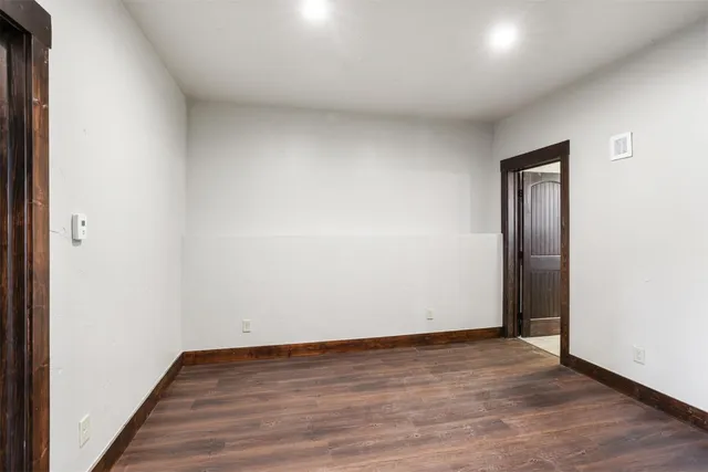 an empty room with wooden floor and closet