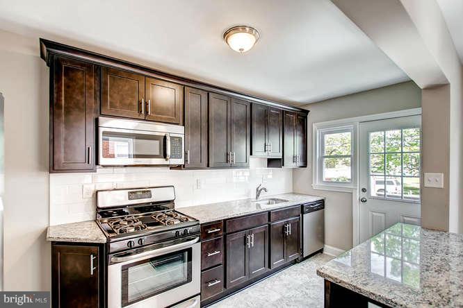 543 Welbrook Road Baltimore, MD 21221 - Photo 11 of 28 a kitchen with stainless steel appliances granite countertop a stove microwave and sink