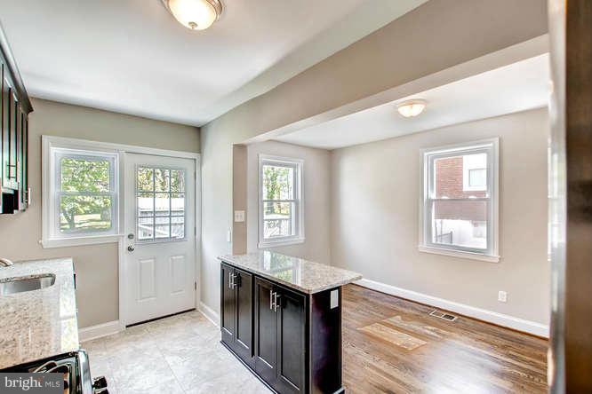 543 Welbrook Road Baltimore, MD 21221 - Photo 13 of 28 a view of an empty room with wooden floor and a window