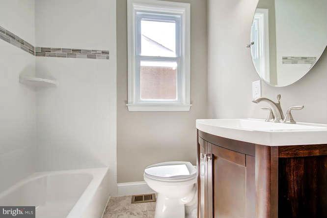 543 Welbrook Road Baltimore, MD 21221 - Photo 17 of 28 a bathroom with a sink a toilet and shower