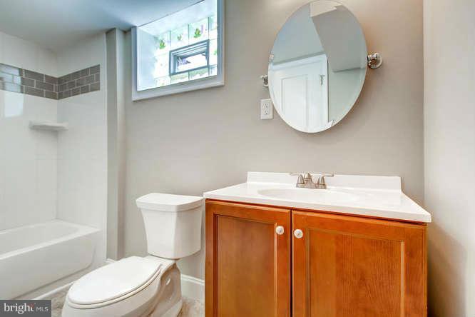 543 Welbrook Road Baltimore, MD 21221 - Photo 24 of 28 a bathroom with a sink a mirror a toilet and a bathtub