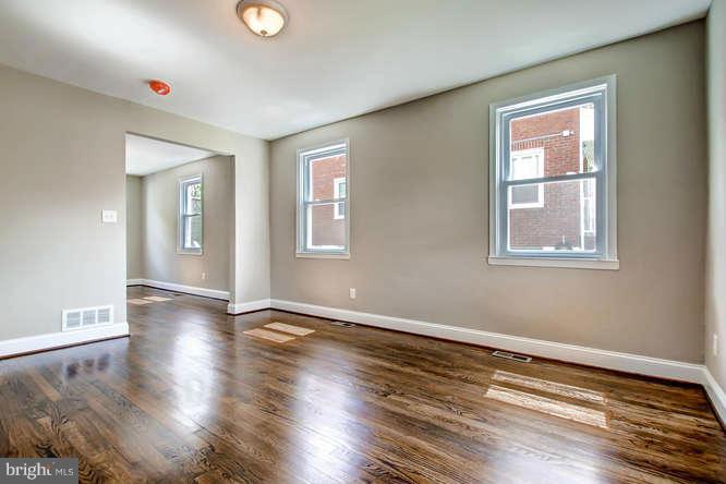 543 Welbrook Road Baltimore, MD 21221 - Photo 7 of 28 a view of an empty room with wooden floor and a window