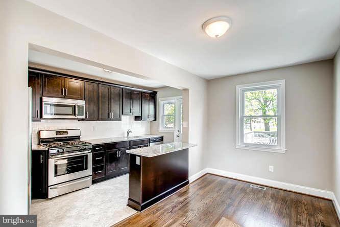 543 Welbrook Road Baltimore, MD 21221 - Photo 8 of 28 a kitchen with stainless steel appliances granite countertop a stove a sink and a microwave
