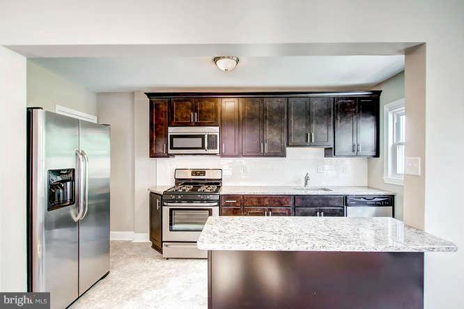 543 Welbrook Road Baltimore, MD 21221 - Photo 10 of 28 a kitchen with stainless steel appliances granite countertop a sink and a stove