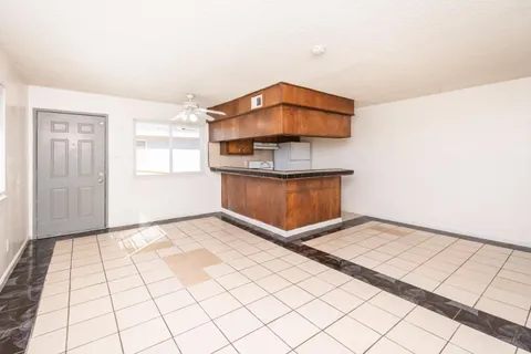 a view of a room with wooden floor
