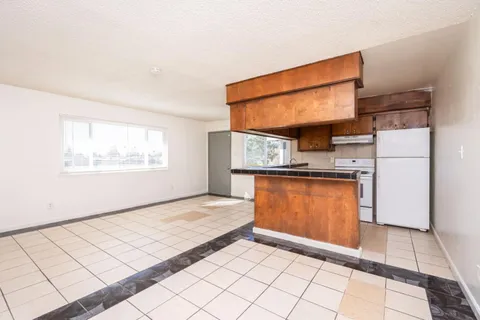 a view of kitchen with refrigerator sink and microwave