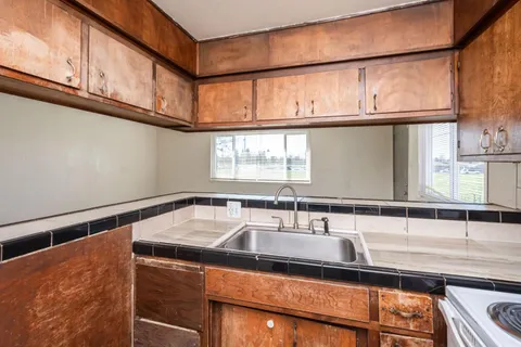 a kitchen with a sink and a window