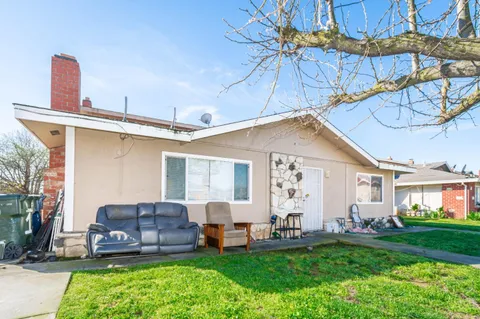a view of a patio with a yard