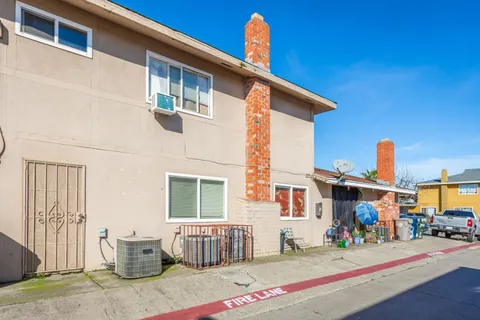 a front view of a building with small garden