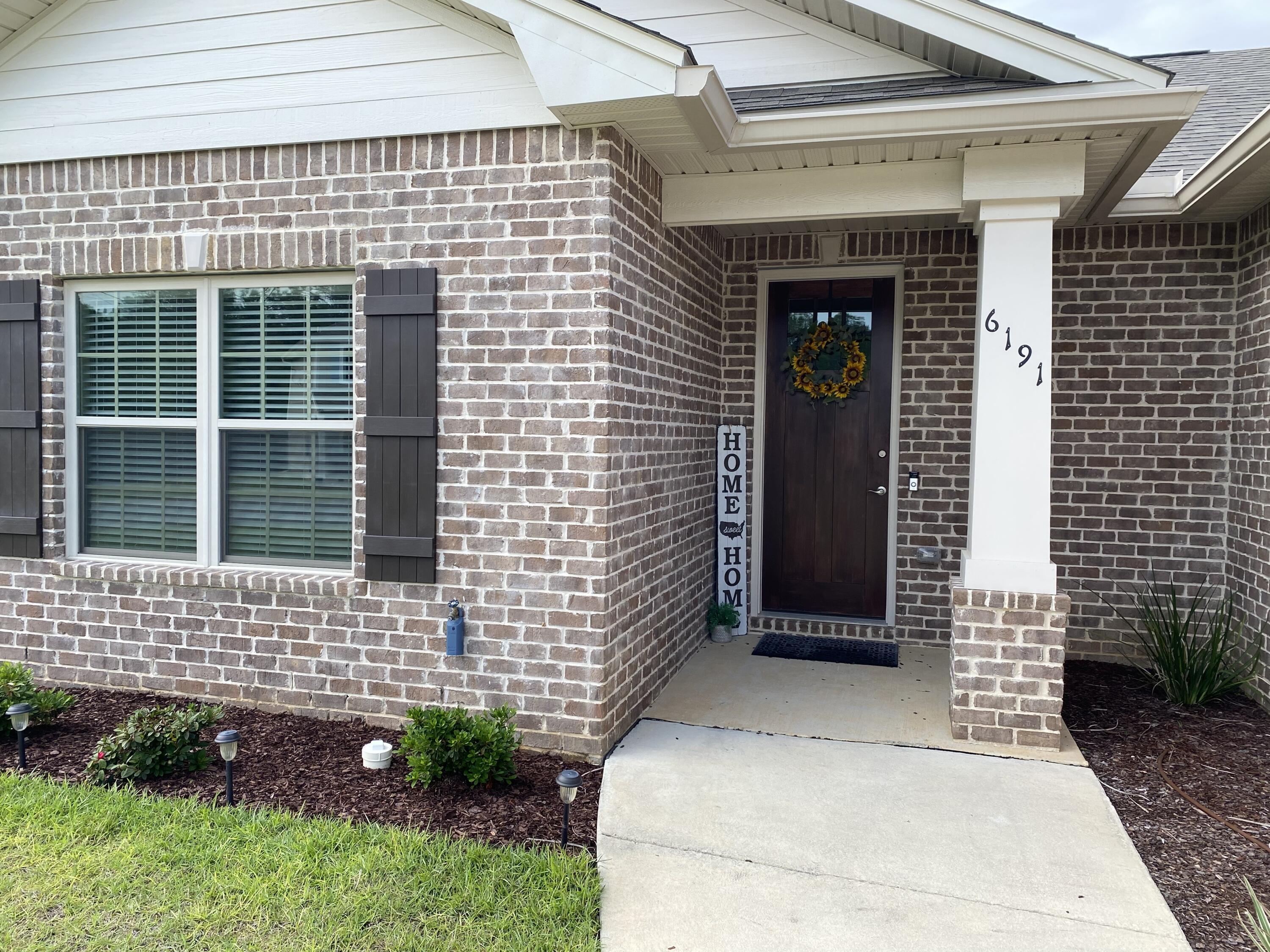 6191 Timberland Ridge Drive Crestview, FL 32539 - Photo 4 of 76 a front view of a house with a garden