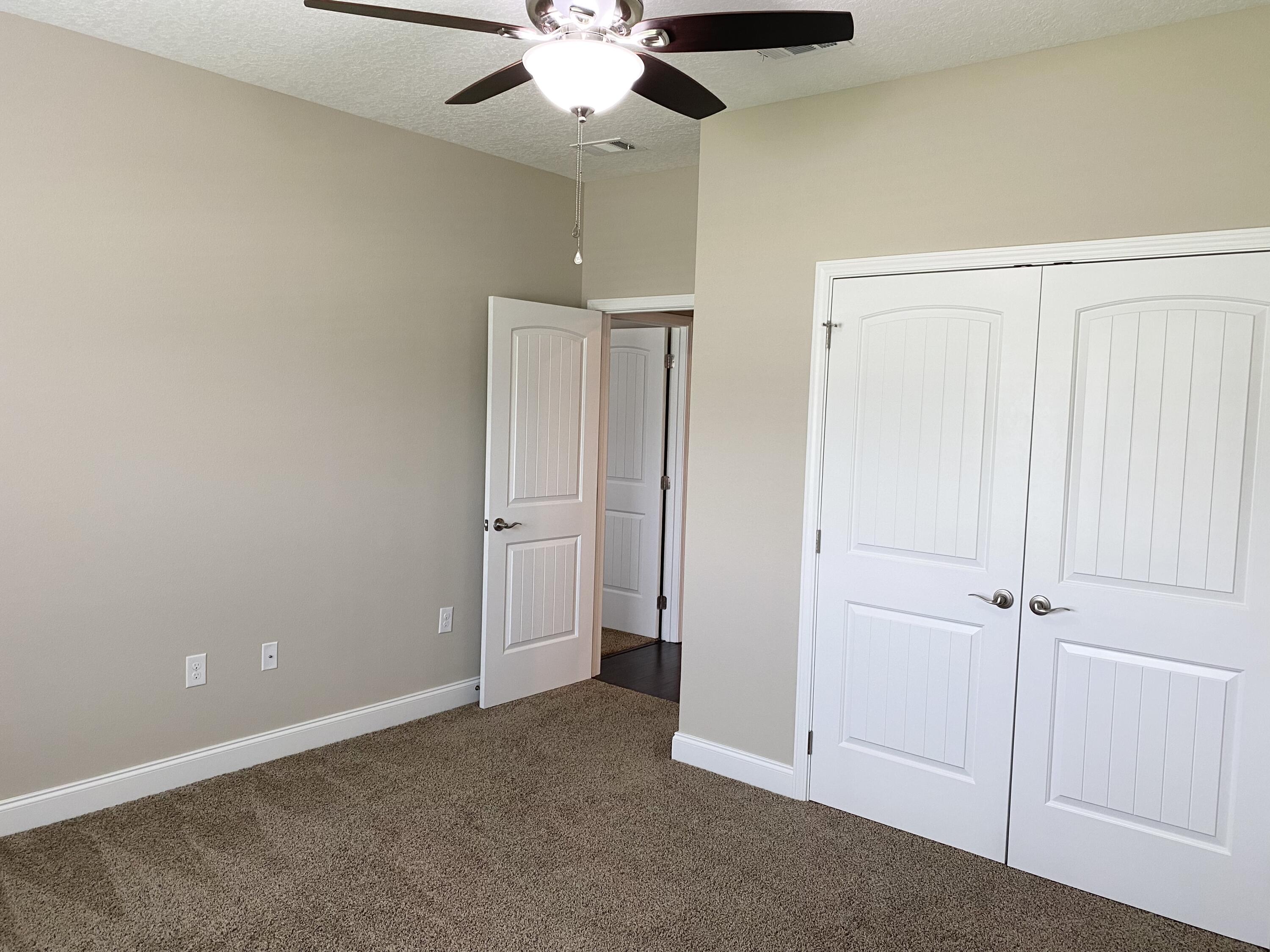 6191 Timberland Ridge Drive Crestview, FL 32539 - Photo 45 of 76 an empty room with closet and a ceiling fan