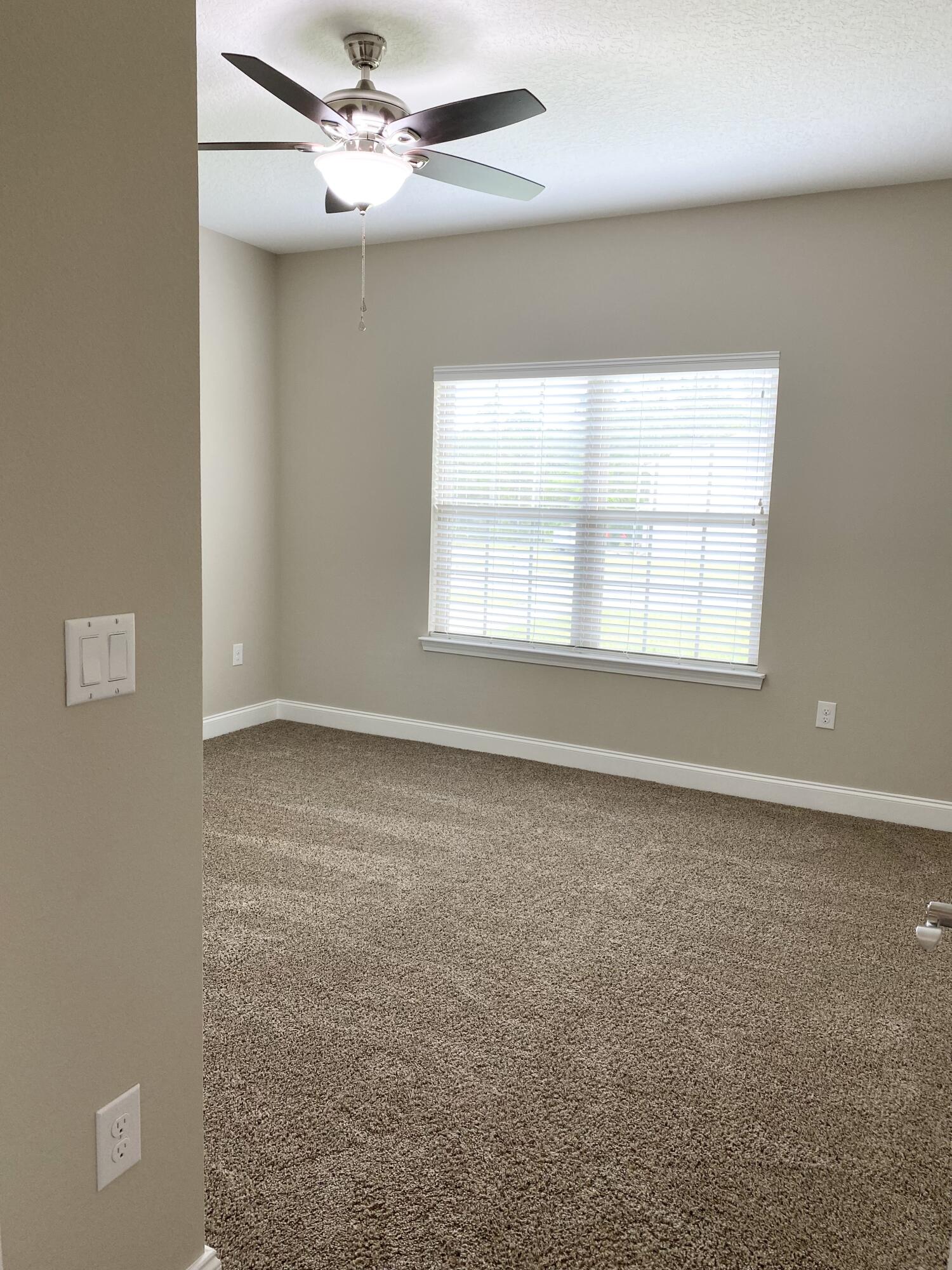 6191 Timberland Ridge Drive Crestview, FL 32539 - Photo 46 of 76 an empty room with windows and fan