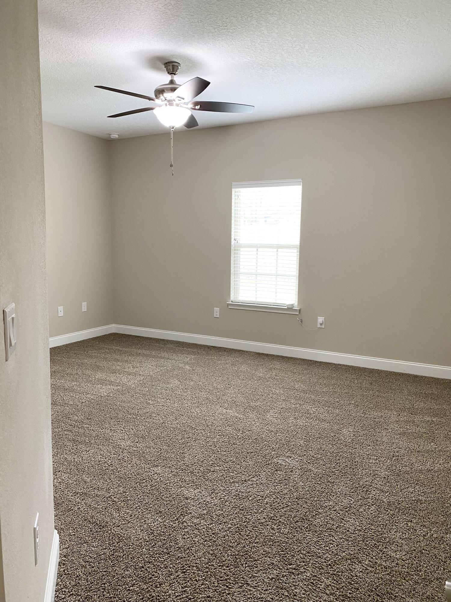6191 Timberland Ridge Drive Crestview, FL 32539 - Photo 54 of 76 an empty room with a window and a ceiling fan