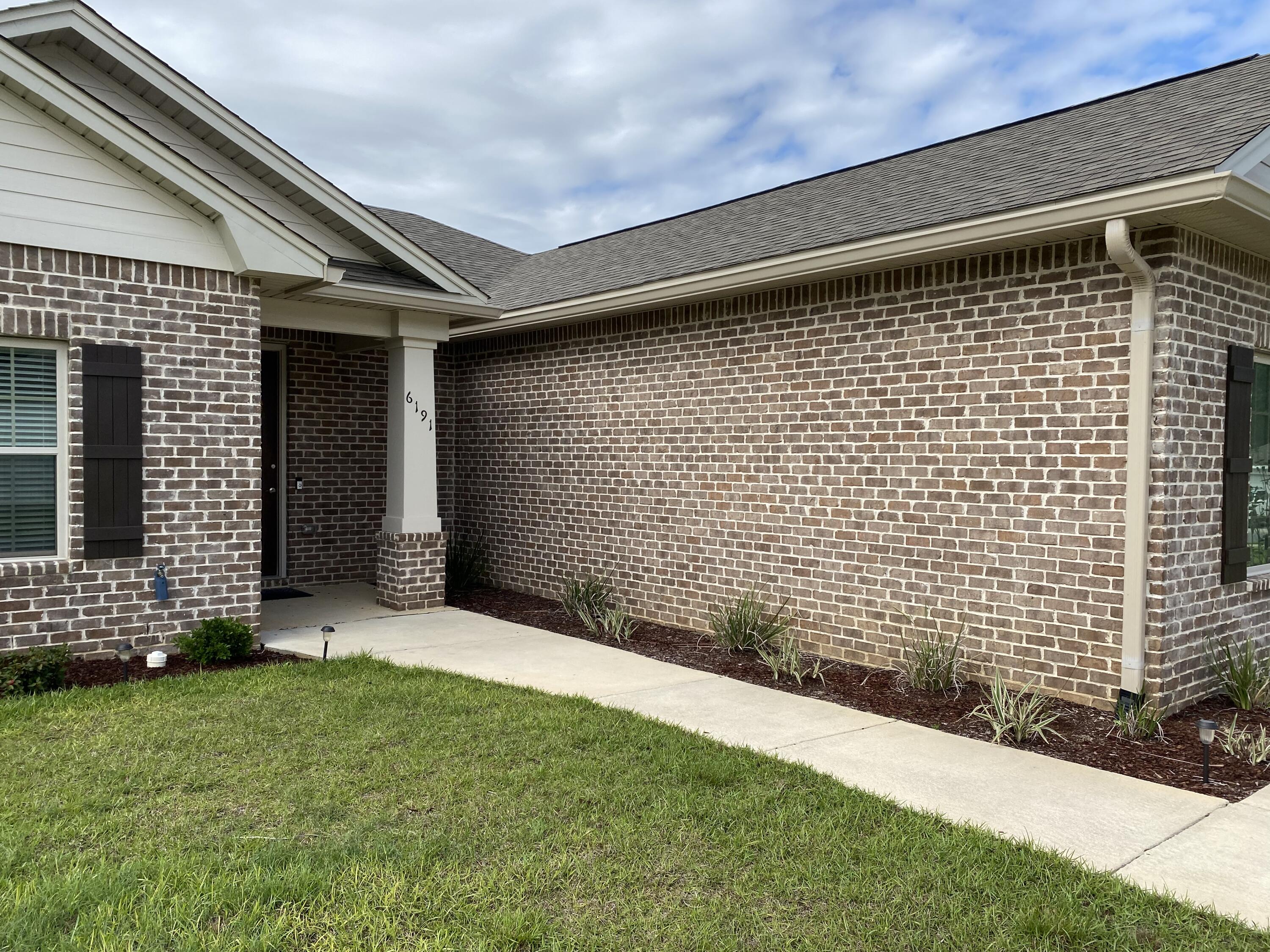 6191 Timberland Ridge Drive Crestview, FL 32539 - Photo 6 of 76 a backyard of a house with lots of green space