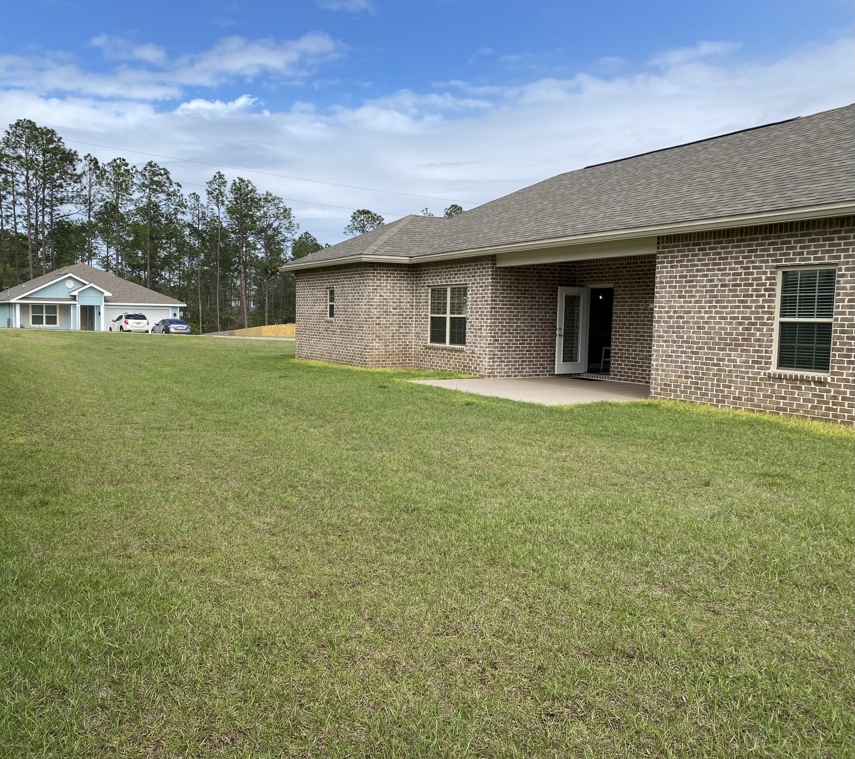 6191 Timberland Ridge Drive Crestview, FL 32539 - Photo 61 of 76 a house that has a tree in front of it