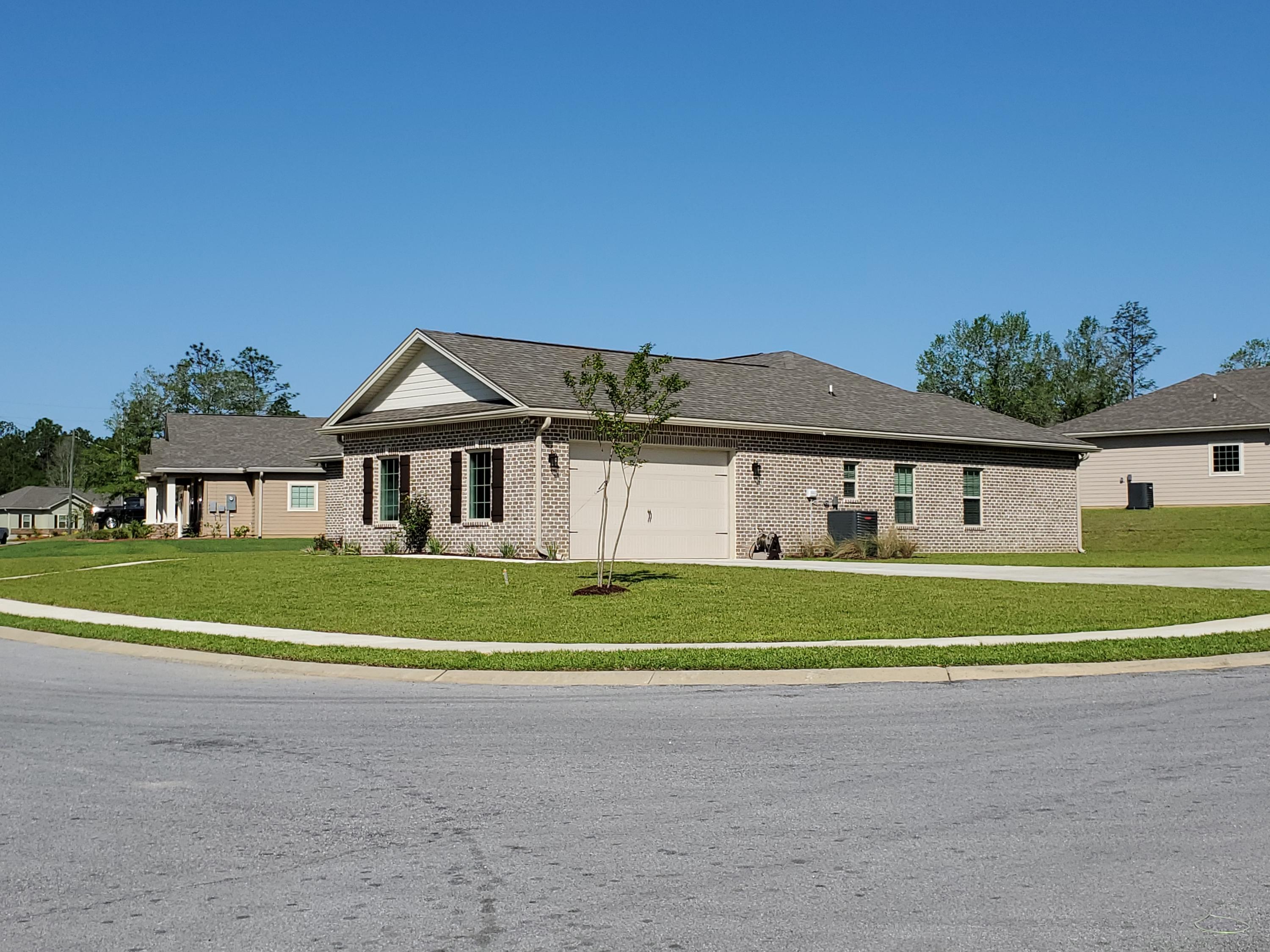6191 Timberland Ridge Drive Crestview, FL 32539 - Photo 63 of 76 a front view of a house with a big yard and a large tree