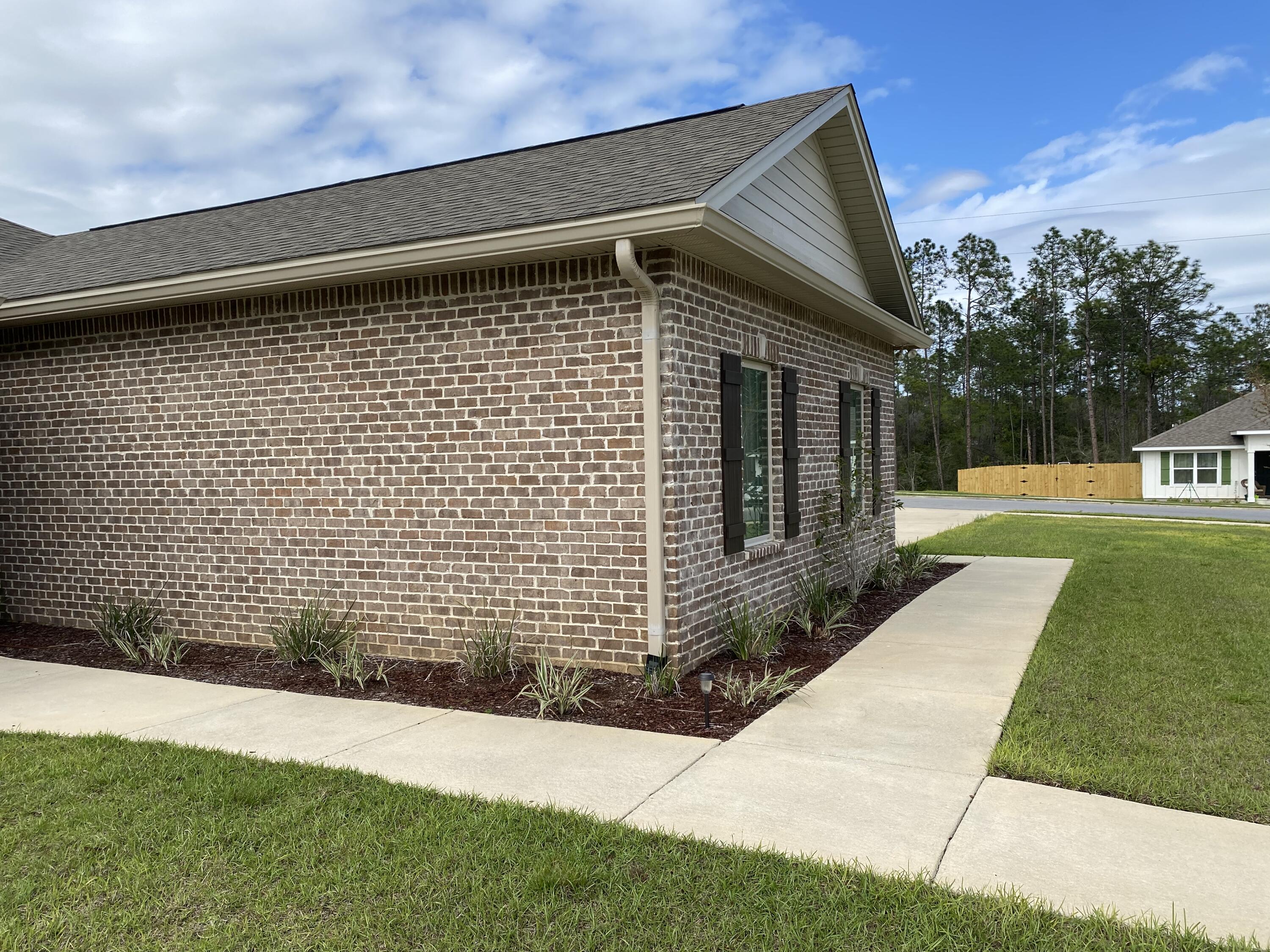 6191 Timberland Ridge Drive Crestview, FL 32539 - Photo 7 of 76 a front view of a house with a yard
