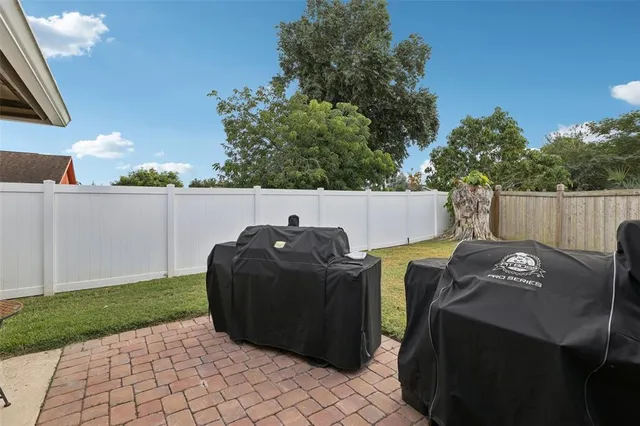 a view of a house with backyard and sitting area