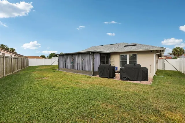 a view of a house with a backyard