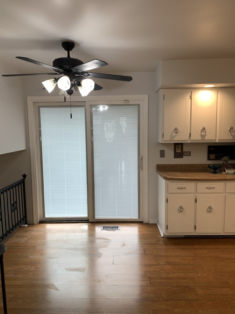 1210 Devonshire Drive Joliet, IL 60435 - Photo 15 of 35 a view of a kitchen with a sink a cabinet and a fireplace